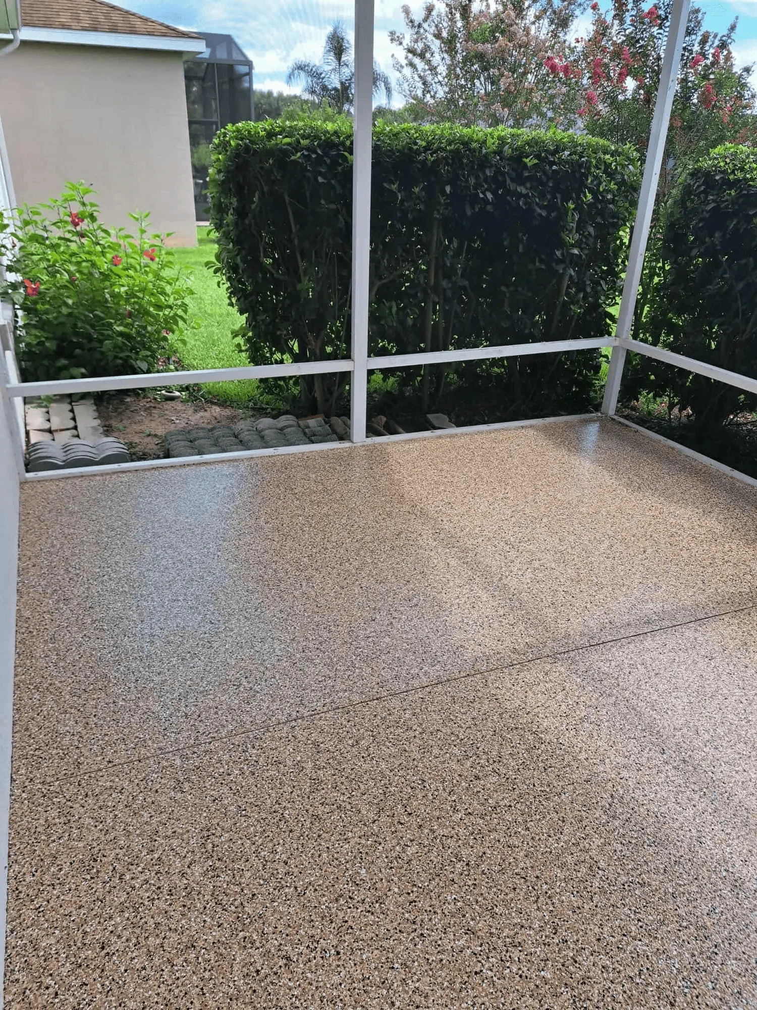 Screened patio with a tan flake floor